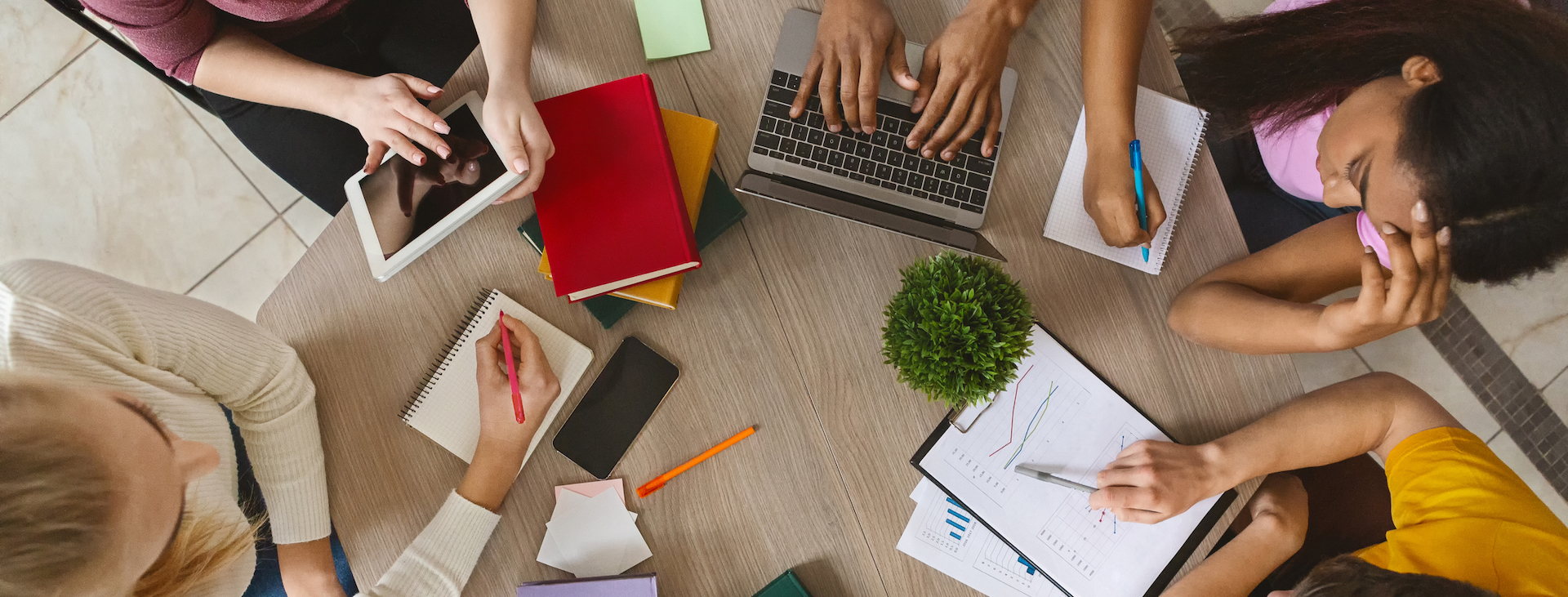 Bird's-eye view of table with laptops, books