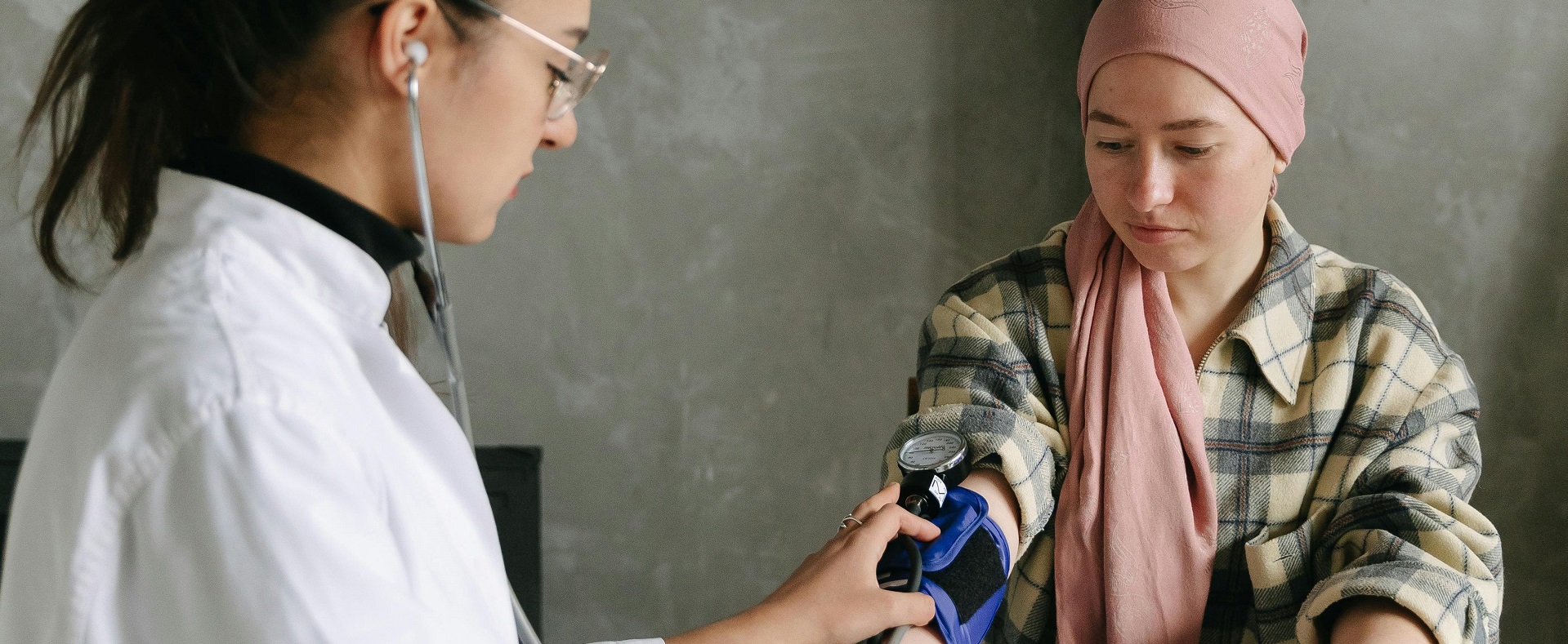 A doctor taking a patient's blood pressure.